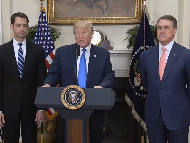 President Donald Trump endorses the RAISE Act while flanked by the bill&#039;s makers, Republican Sens. Tom Cotton of Arkansas, left, and David Perdue of Georgia. (Screenshot of White House video)
